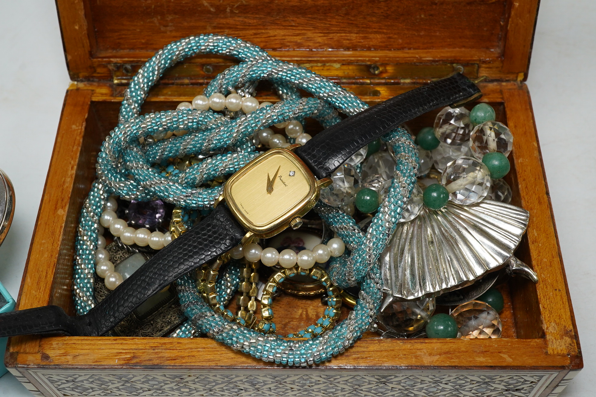 A small quantity of assorted costume jewellery including a Scottish hardstone brooch and a Tiffany & Co. folding silver mirror. Condition - fair to good